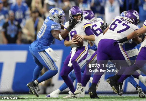 Kirk Cousins of the Minnesota Vikings is hit by Jarrad Davis of the Detroit Lions during the first quarter of the game at Ford Field on December 11,...