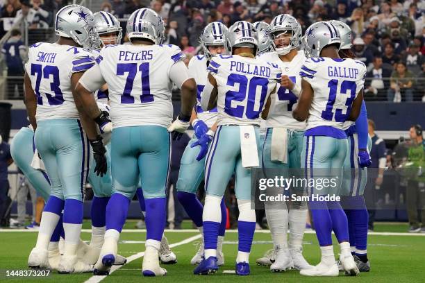 The Dallas Cowboys offense huddles in the second quarter of a game against the Houston Texans at AT&T Stadium on December 11, 2022 in Arlington,...