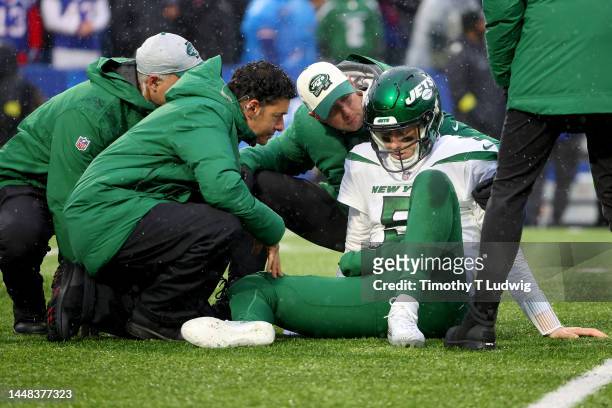 Mike White of the New York Jets is looked at by the medical staff during the first half against the Buffalo Bills at Highmark Stadium on December 11,...