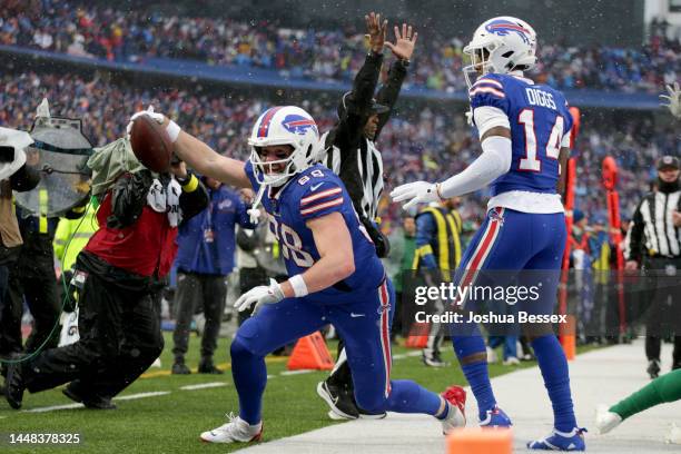 Dawson Knox of the Buffalo Bills scores a touchdown in the second quarter of a game against the New York Jets at Highmark Stadium on December 11,...