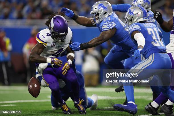 Dalvin Cook of the Minnesota Vikings fumbles as he is hit by Isaiah Buggs of the Detroit Lions during the 1st half of the game at Ford Field on...