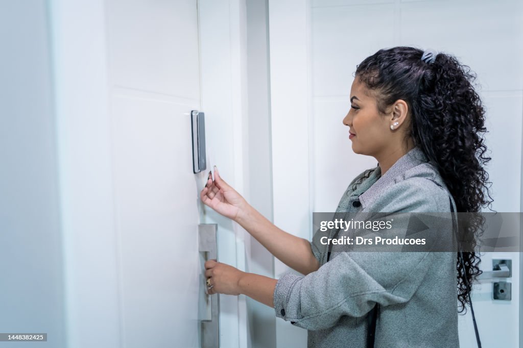 Woman using electronic card to open the door