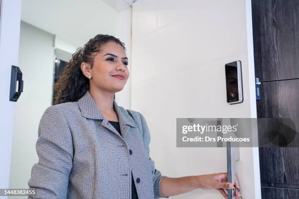woman using electronic card to open the door - door close button imagens e fotografias de stock