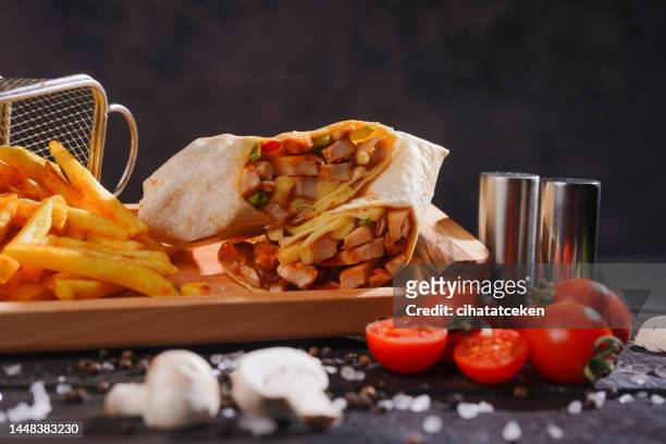 eastern traditional shawarma with sauces - wrapped burrito stock pictures, royalty-free photos & images
