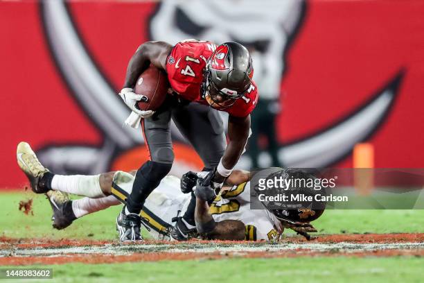Chris Godwin of the Tampa Bay Buccaneers makes a catch against Bradley Roby of the New Orleans Saints at Raymond James Stadium on December 5, 2022 in...