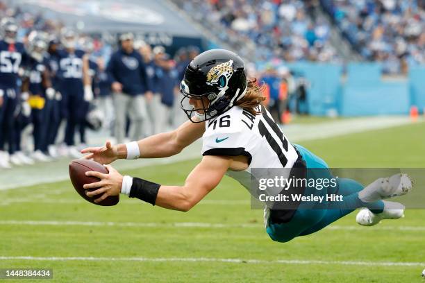 Trevor Lawrence of the Jacksonville Jaguars dives in for a touchdown in the third quarter of the game against the Tennessee Titans at Nissan Stadium...