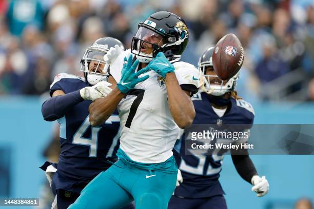 Zay Jones of the Jacksonville Jaguars drops a pass as Andrew Adams and Terrance Mitchell of the Tennessee Titans defend in the third quarter of the...