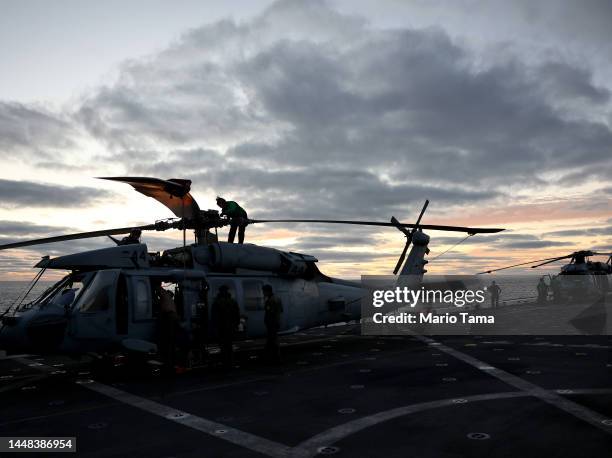 Navy airmen prepare MH-60S Seahawk helicopters for flight as part of recovery operations before NASA's Orion Capsule splashed down after a successful...