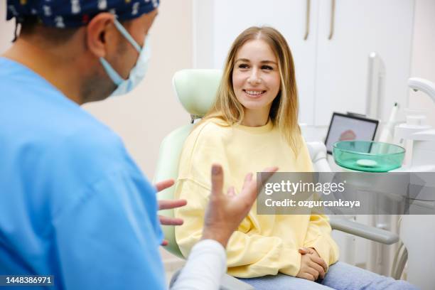 blonde female patient sitting on dentist chair and smiling - dental crown stock pictures, royalty-free photos & images