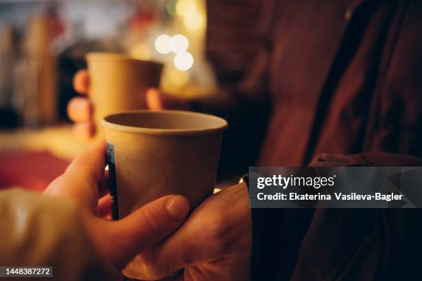 hands holding mulled wine at the christmas market - kids advent stock pictures, royalty-free photos & images