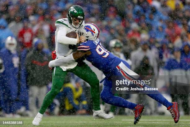 Mike White of the New York Jets gets sacked by Shaq Lawson of the Buffalo Bills in the fourth quarter at Highmark Stadium on December 11, 2022 in...
