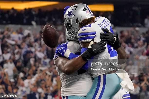 Ezekiel Elliott of the Dallas Cowboys celebrates with Tyler Smith of the Dallas Cowboys in the fourth quarter of a game against the Houston Texans at...