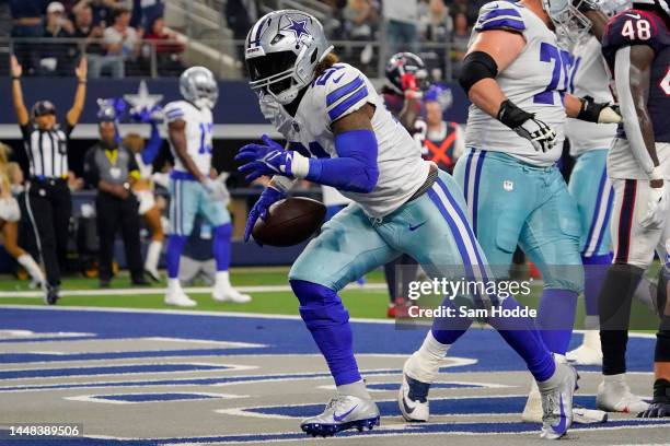 Ezekiel Elliott of the Dallas Cowboys scores a touchdown in the fourth quarter of a game against the Houston Texans at AT&T Stadium on December 11,...