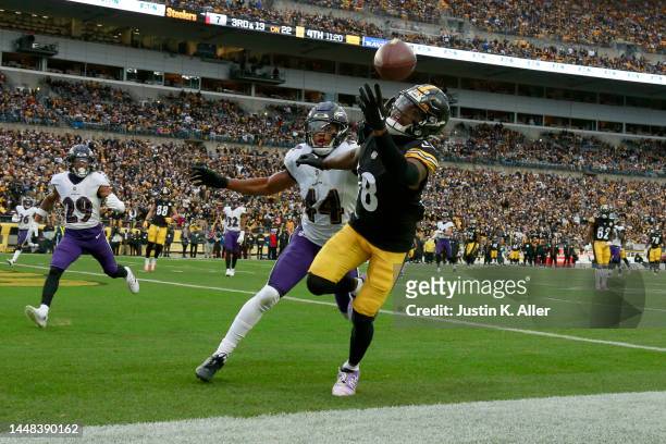 Diontae Johnson of the Pittsburgh Steelers reaches for a pass which would go incomplete as Marlon Humphrey of the Baltimore Ravens covers during the...