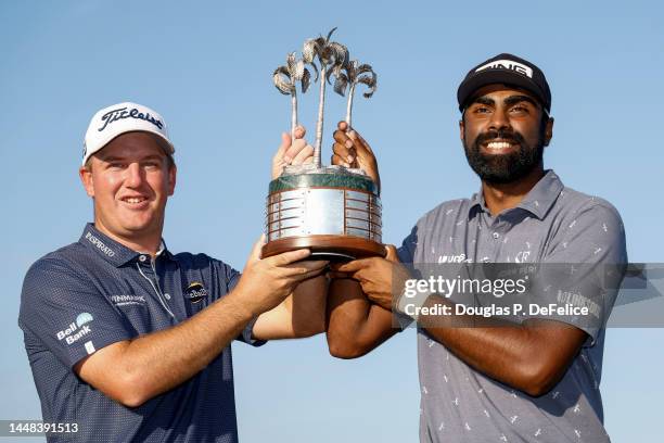 Tom Hoge and Sahith Theegala of the United States pose with the trophy on the eighteenth green after winning the QBE Shootout at Tiburon Golf Club on...