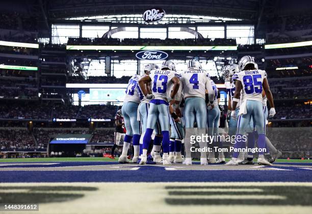 The Dallas Cowboys offense huddles in the fourth quarter of a game against the Houston Texans at AT&T Stadium on December 11, 2022 in Arlington,...