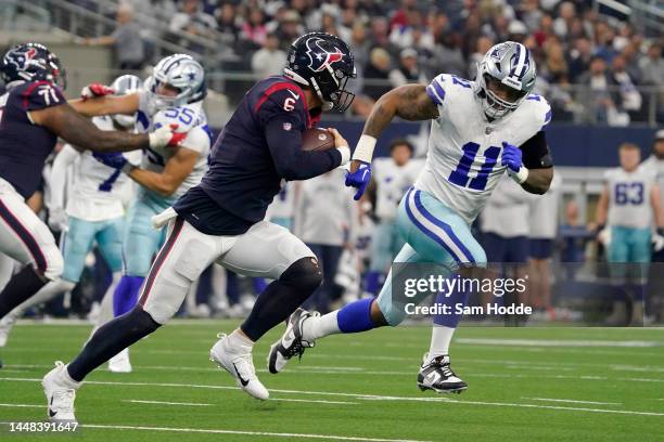 Jeff Driskel of the Houston Texans runs with the ball as Micah Parsons of the Dallas Cowboys makes chase in the fourth quarter at AT&T Stadium on...