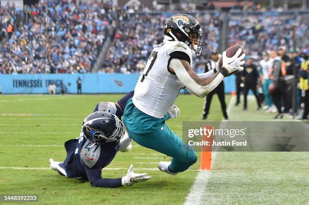 Evan Engram of the Jacksonville Jaguars makes a catch for a touchdown as Andrew Adams of the Tennessee Titans attempts the tackle during the third...