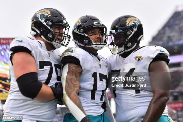 Luke Fortner, Evan Engram and Cam Robinson of the Jacksonville Jaguars react after Engrams touchdown in the third quarter of the game against the...