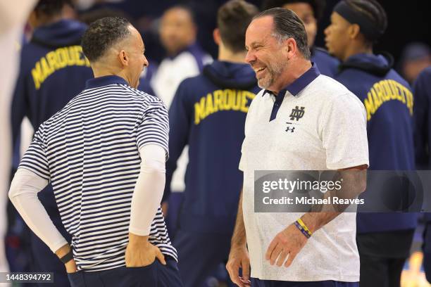 Head coach Shaka Smart of the Marquette Golden Eagles laughs with head coach Mike Brey of the Notre Dame Fighting Irish prior to the game at the...