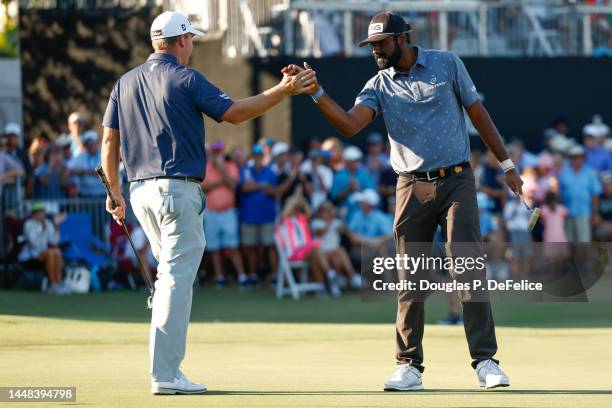 Sahith Theegala celebrates with Tom Hoge of the United States after putting the winning birdie on the eighteenth green during the final round of the...