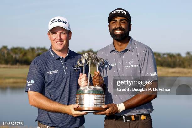 Tom Hoge and Sahith Theegala of the United States pose with the trophy on the eighteenth green after winning the QBE Shootout at Tiburon Golf Club on...