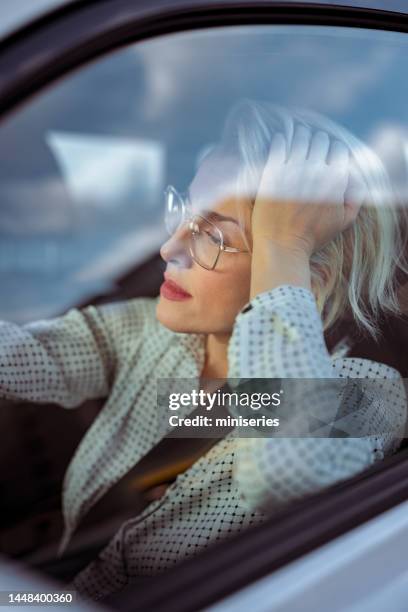 bored businesswoman driving car - unhappy woman blonde glasses stock pictures, royalty-free photos & images