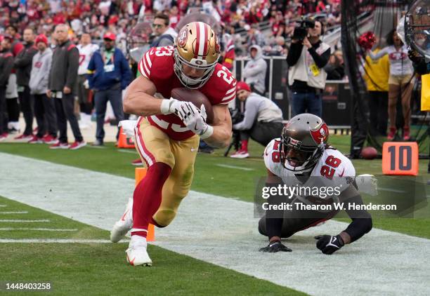 Christian McCaffrey of the San Francisco 49ers catches a pass against Logan Ryan of the Tampa Bay Buccaneers for a touchdown during the first half at...