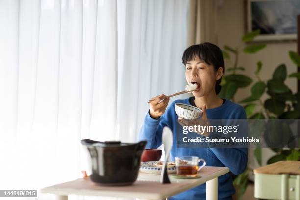 a woman inviting friends to her home for lunch. - japanese chopsticks stock pictures, royalty-free photos & images