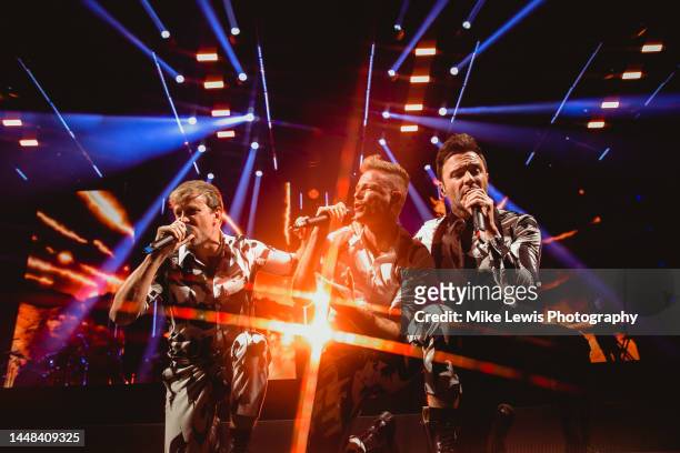 Kian Egan, Nicky Byrne and Shane Filan of Westlife perform on stage at Cardiff International Arena on December 11, 2022 in Cardiff, Wales.