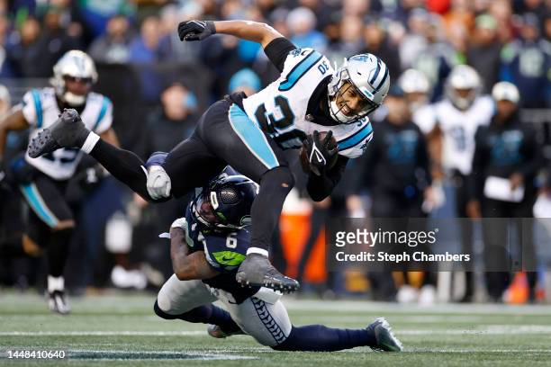 Chuba Hubbard of the Carolina Panthers is tackled by Quandre Diggs of the Seattle Seahawks in the fourth quarter of the game at Lumen Field on...