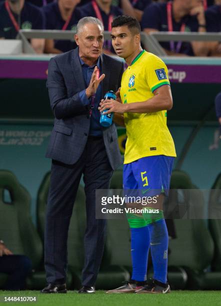 Casemiro of Brazil talks to manager Tite during the FIFA World Cup Qatar 2022 quarter final match between Croatia and Brazil at Education City...