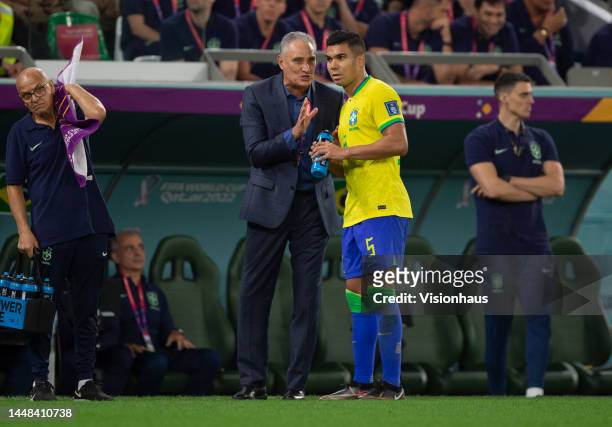 Casemiro of Brazil talks to manager Tite during the FIFA World Cup Qatar 2022 quarter final match between Croatia and Brazil at Education City...