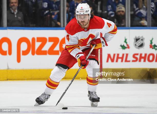 Rasmus Andersson of the Calgary Flames skates with the puck against the Toronto Maple Leafs during an NHL game at Scotiabank Arena on December 10,...