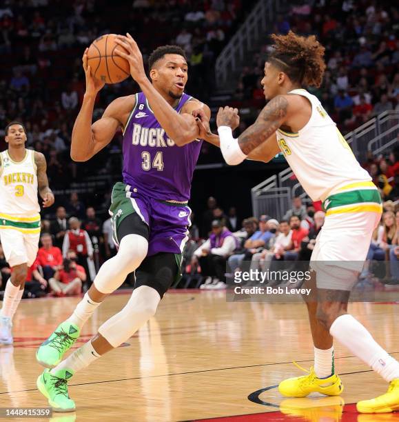 Giannis Antetokounmpo of the Milwaukee Bucks drives toward the basket on Jalen Green of the Houston Rockets during the second quarter at Toyota...