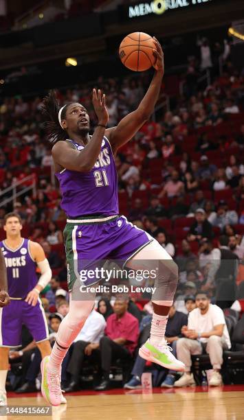 Jrue Holiday of the Milwaukee Bucks drives to the hoop against the Houston Rockets during the second quarter at Toyota Center on December 11, 2022 in...