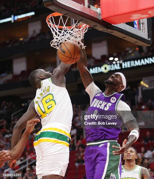 Bobby Portis of the Milwaukee Bucks dunks over Usman Garuba of the Houston Rockets during the second quarter at Toyota Center on December 11, 2022 in...