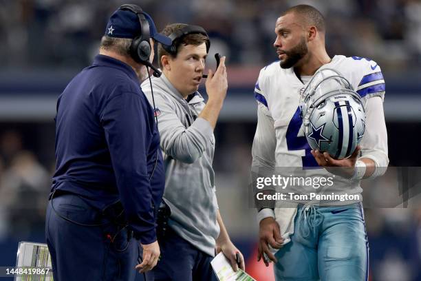 Quarterback Dak Prescott of the Dallas Cowboys talks with offensive coordinator Kellen Moore and head coach Mike McCarthy of the Dallas Cowboys...