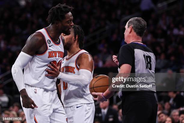 Jalen Brunson holds back Julius Randle of the New York Knicks as he argues with a referee after being ejected during the third quarter of the game...