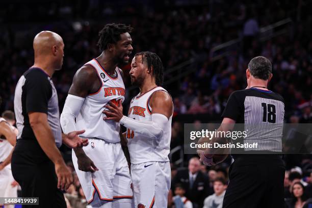 Jalen Brunson holds back Julius Randle of the New York Knicks as he argues with a referee after being ejected during the third quarter of the game...