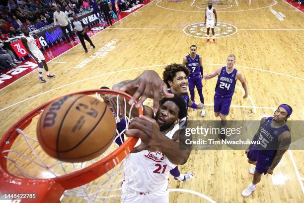 Joel Embiid of the Philadelphia 76ers dunks past Kelly Oubre Jr. #12 of the Charlotte Hornets during the second quarter at Wells Fargo Center on...