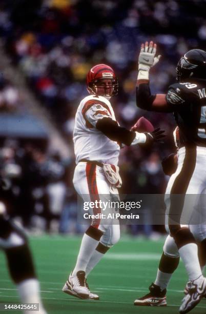 Quarterback Boomer Esiason of the Cincinnati Bengals looks to pass the ball in the game between the Cincinnati Bengals vs the Philadelphia Eagles at...