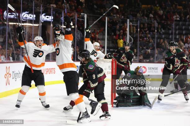 Travis Konecny of the Philadelphia Flyers celebrates with Morgan Frost after scoring a goal against goaltender Karel Vejmelka of the Arizona Coyotes...