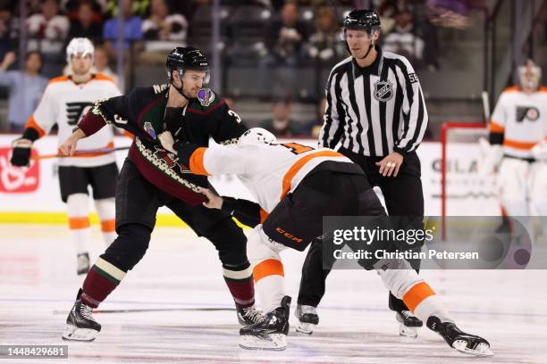 Josh Brown of the Arizona Coyotes fights with Zack MacEwen of the Philadelphia Flyers during the third period of the NHL game at Mullett Arena on...