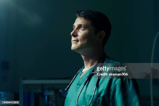 portrait of professional surgeons in operating room and darken background copy space - professional portrait ストックフォトと画像