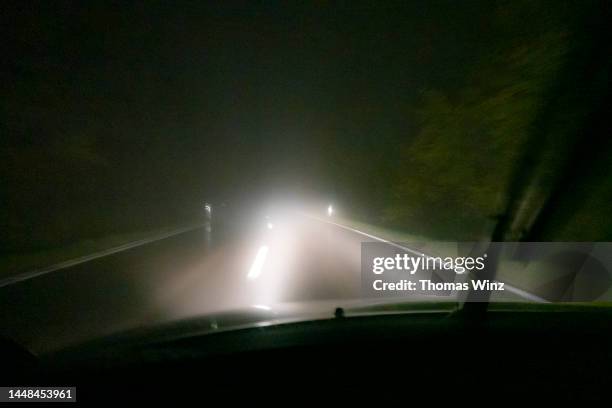 driving at night in dangerous conditions - rain night ストックフォトと画像