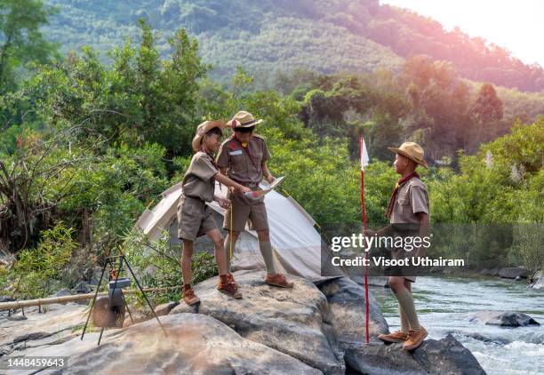 boy scout walking in forest. - boy scouts of america stock pictures, royalty-free photos & images