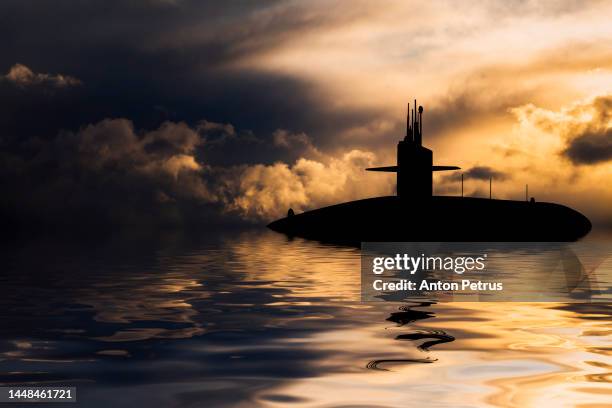 nuclear submarine at sea at sunset. submarine fleet - sub stock pictures, royalty-free photos & images