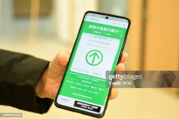 Man shows his travel code on a mobile phone on December 12, 2022 in Suzhou, Jiangsu Province of China.