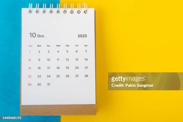 calendar desk 2023: october is the month for the organizer to plan and deadline with a two-tone paper background. - oktober stock pictures, royalty-free photos & images